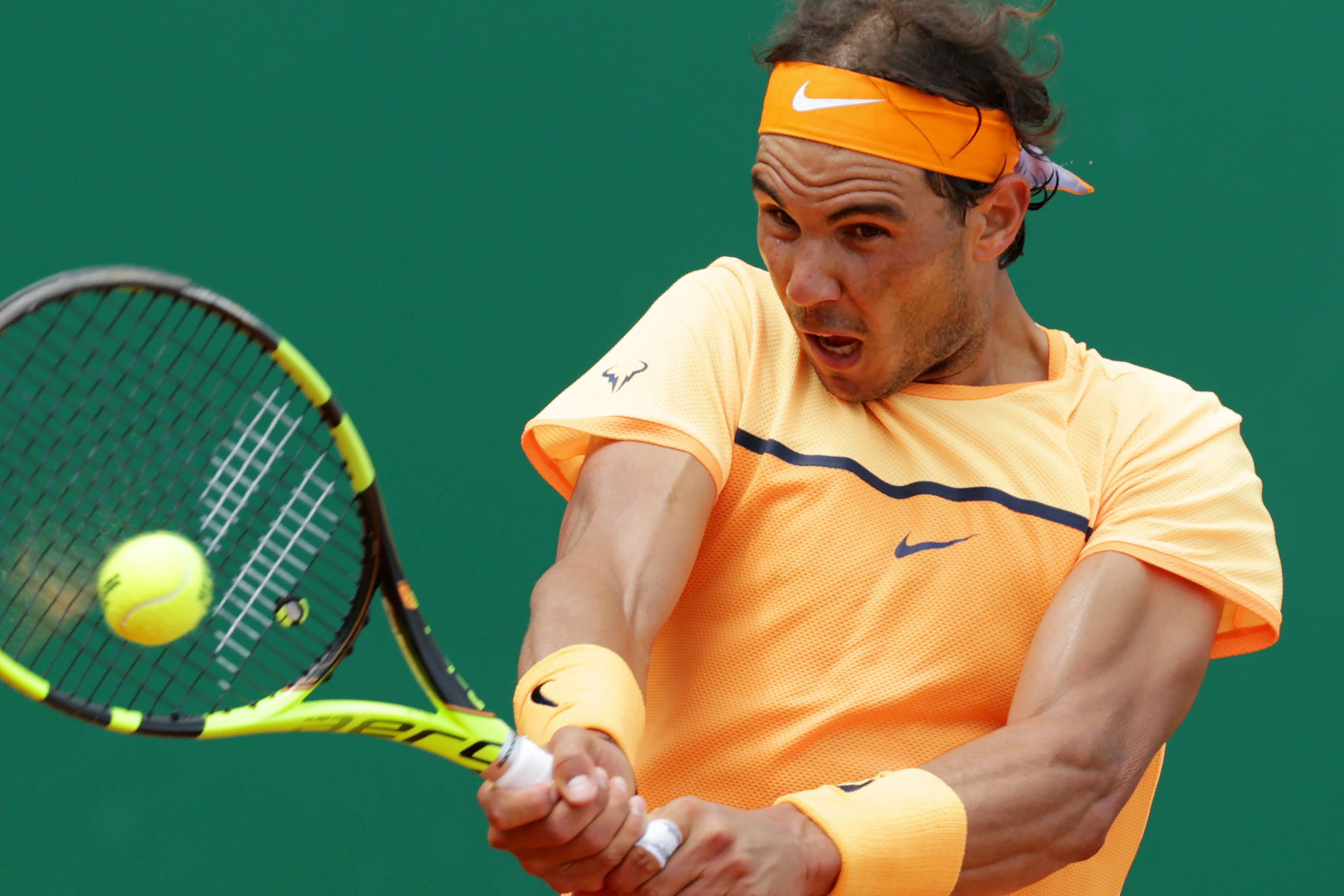 Spain's Rafael Nadal returns the ball to France's Gael Monfils during the final match at the Monte-Carlo ATP Masters Series Tournament in Monaco on April 17, 2016. Nadal defeated Monfils 7-5, 5-7, 6-0 to win a record ninth title at the Monte Carlo Masters. AFP PHOTO / JEAN CHRISTOPHE MAGNENET